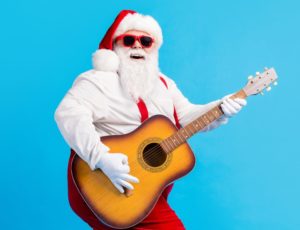 Full size photo of crazy cool santa claus with big belly beard play guitar x-mas christmas performance wear sunglass suspenders overalls isolated over blue color background